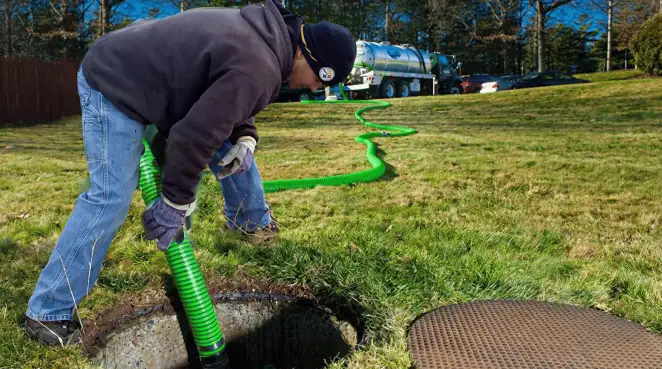 Service technician performing residential septic pumping and drainage maintenance in Lincoln, NE